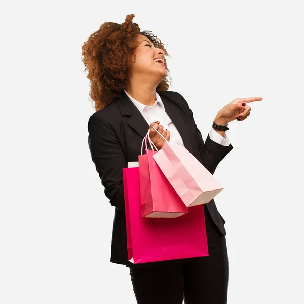 Young Black Woman Holding Shopping Bags Pointing Side Finger — Stock Photo, Image