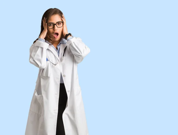 Full body young doctor woman surprised and shocked