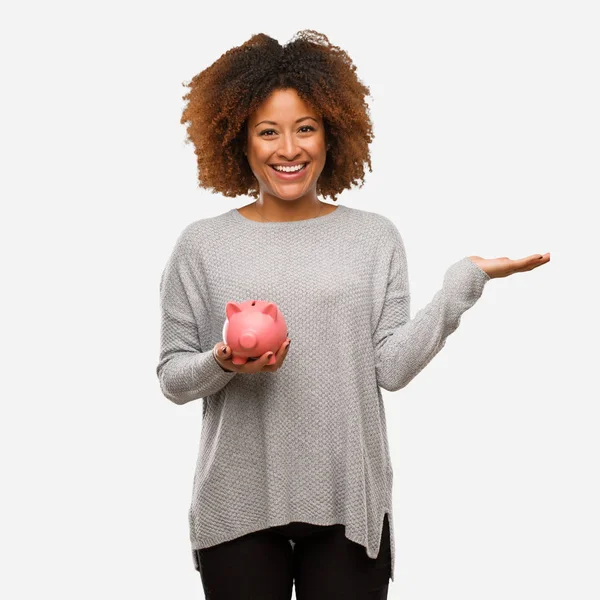 Jovem Mulher Negra Segurando Porquinho Banco Segurando Algo Com Mão — Fotografia de Stock