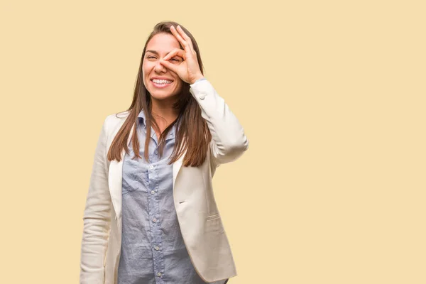Caucasian business young woman confident doing ok gesture on eye