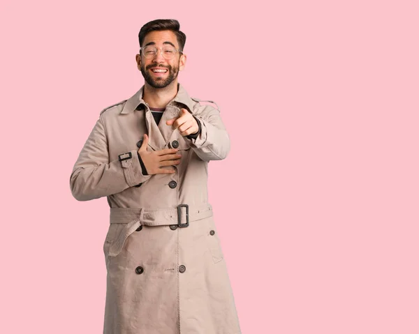 Young man wearing trench coat dreams of achieving goals and purposes