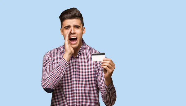 Joven Sosteniendo Tarjeta Crédito Gritando Algo Feliz Frente — Foto de Stock