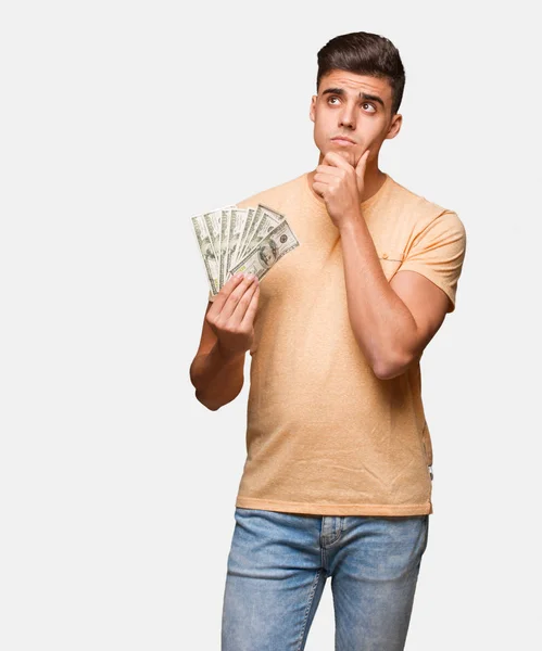 Young Man Holding Dollars Thinking Idea — Stock Photo, Image