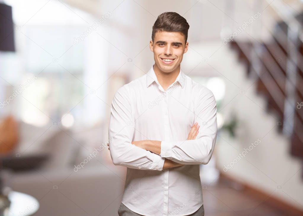 Young business cool man crossing arms, smiling and relaxed