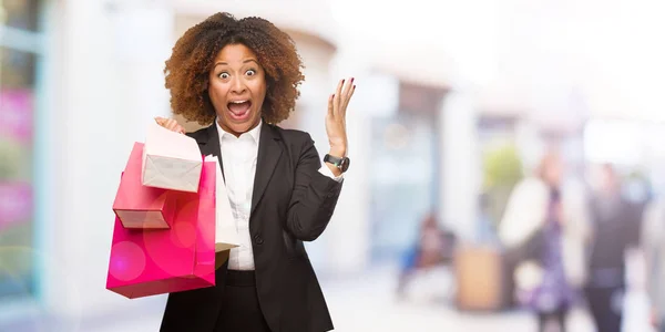 Young Black Woman Holding Shopping Bags Celebrating Victory Success — Stock Photo, Image