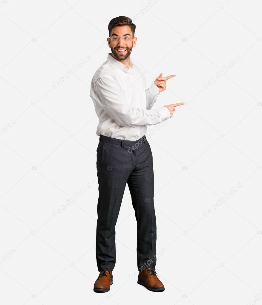 Young handsome business man pointing to the side with finger