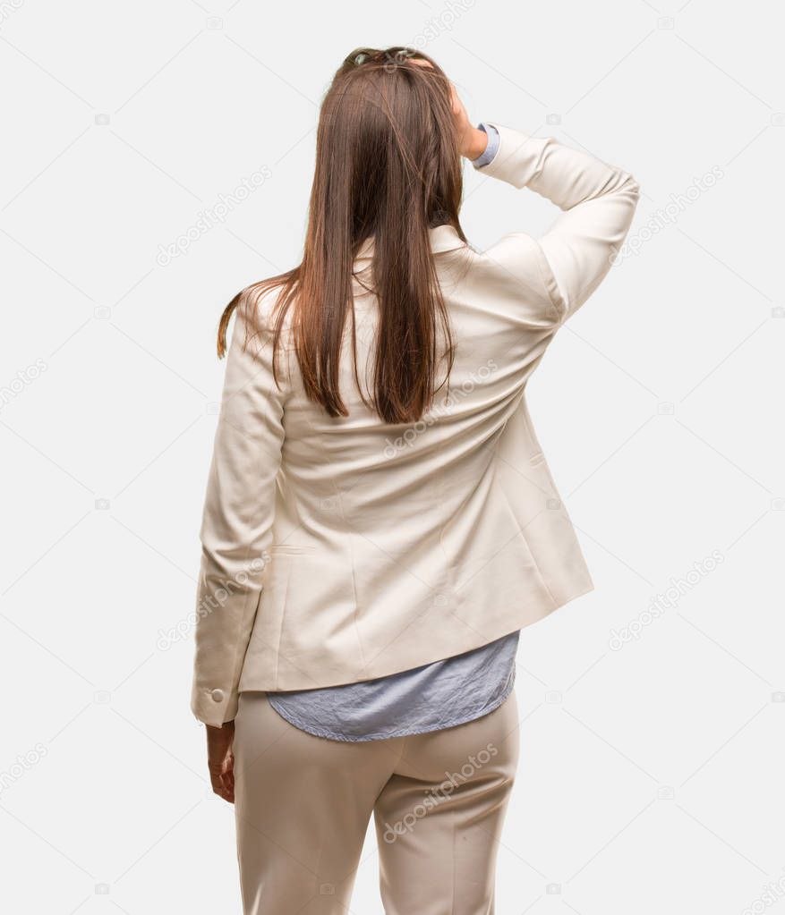 Caucasian business young woman from behind thinking about something