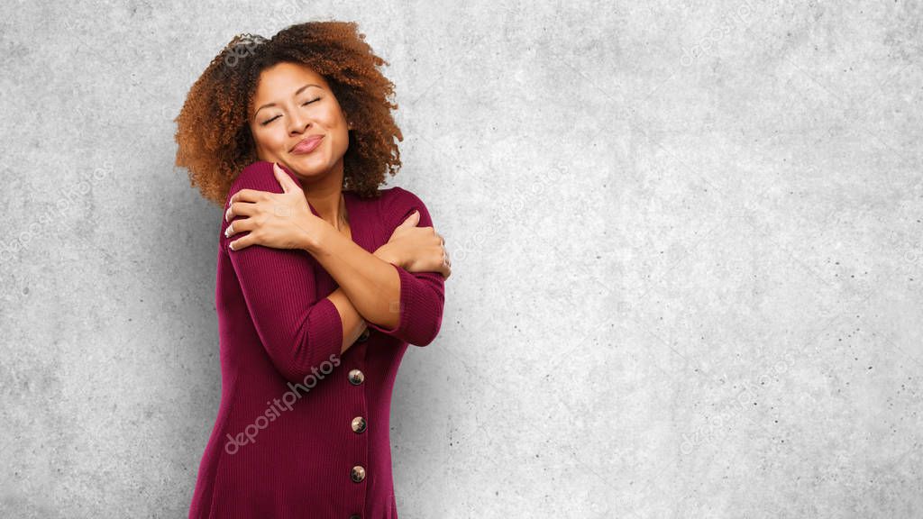 Young black afro woman giving a hug