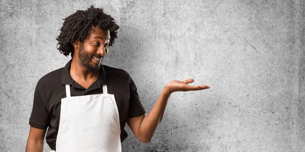 Handsome African American Baker Holding Something Hands Showing Product Smiling — Stock Photo, Image