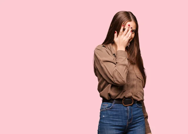 Young caucasian woman embarrassed and laughing at the same time