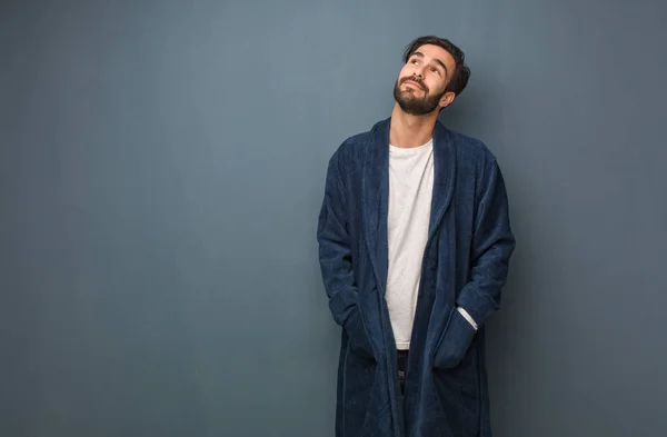Man wearing pajama dreaming of achieving goals and purposes