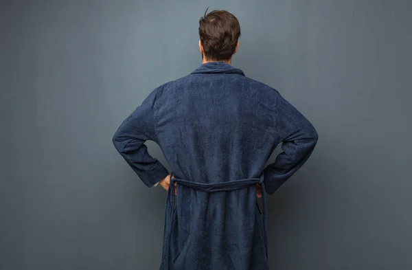 Man wearing pajama from behind, looking back