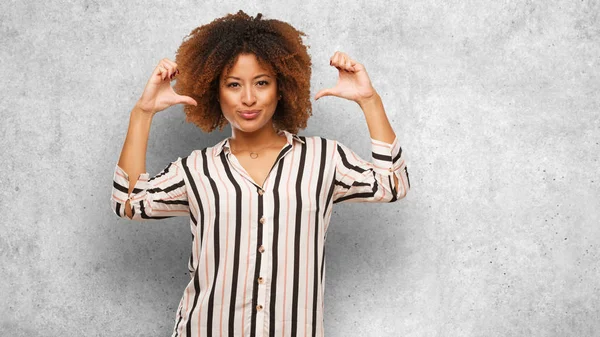 Young black afro woman pointing fingers, example to follow