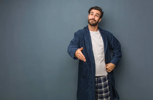 Man wearing pajama holding something with hand