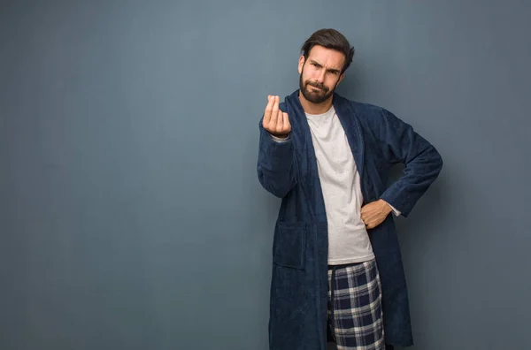 Man wearing pajama doing a typical italian gesture
