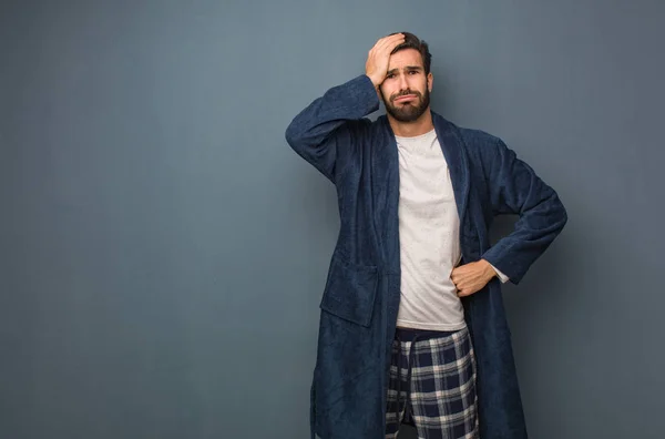 Man wearing pajama worried and overwhelmed