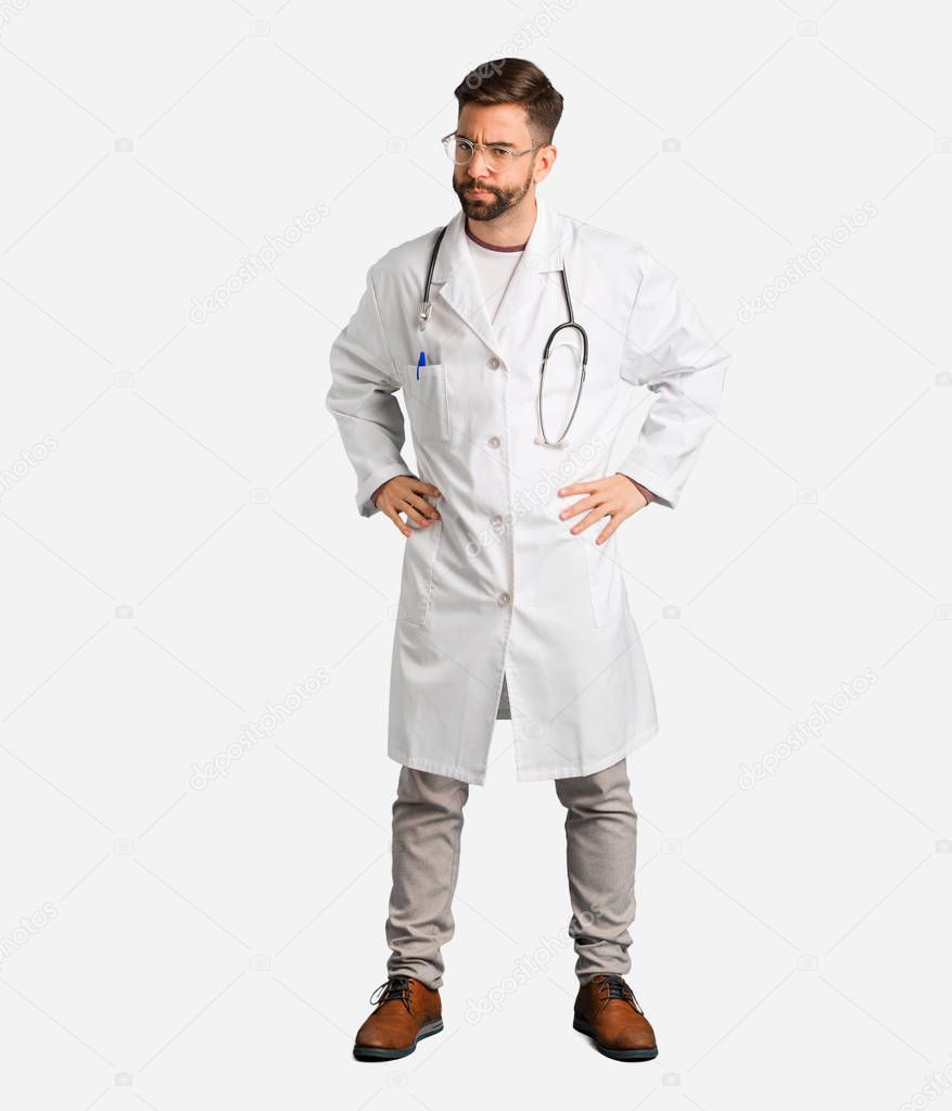 Young doctor man scolding someone very angry