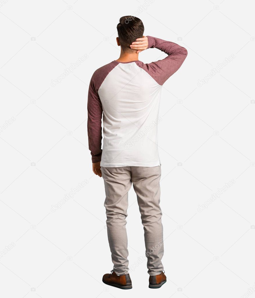 Young handsome man from behind thinking about something