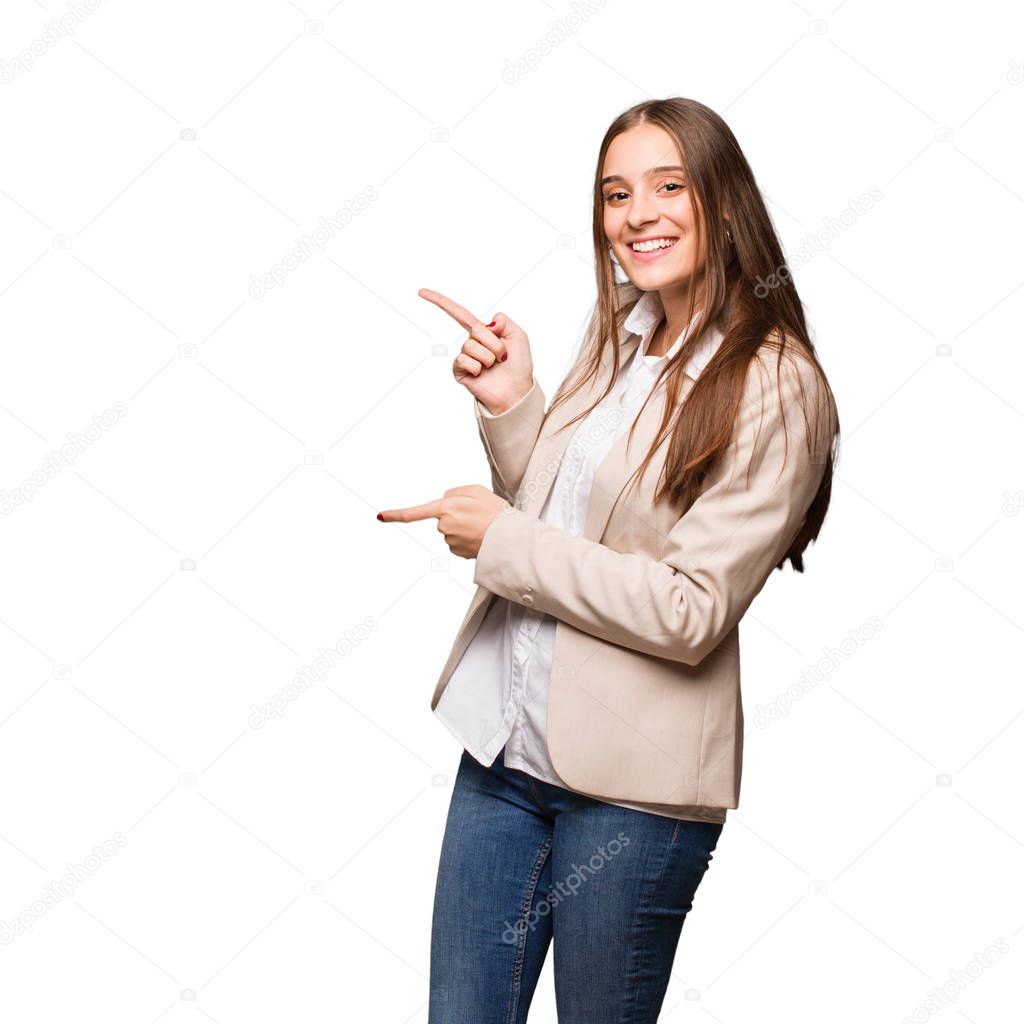 Young caucasian business woman pointing to the side with finger