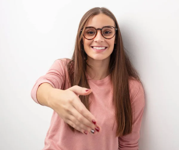 Young cute woman reaching out to greet someone