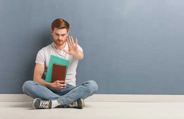 Young Redhead Student Man Sitting Floor Putting Hand Front Holding — Stock Photo, Image