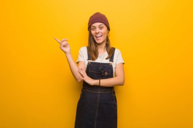 Yan parmak ile işaret eden genç hipster kadın