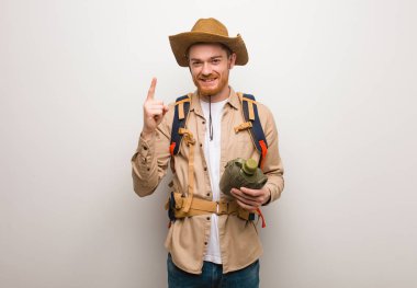 Genç redhead explorer adam gösteren bir numara. Bir kantin tutuyor.