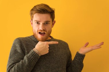 Genç Redhead adam yüz kapatmak tutan bir şey ile el