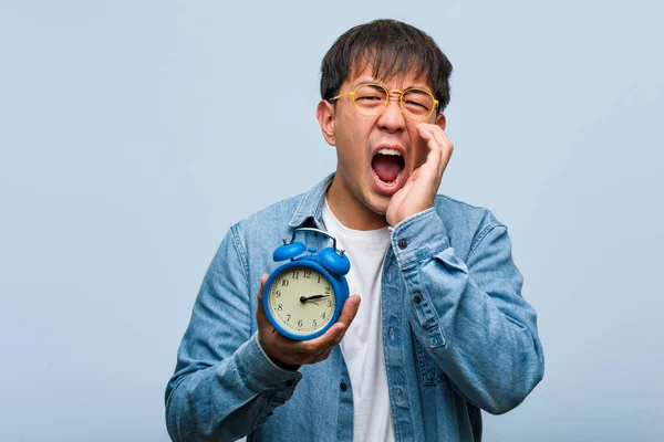 Young Chinese Man Holding Alarm Clock Shouting Something Happy Front — Stock Photo, Image