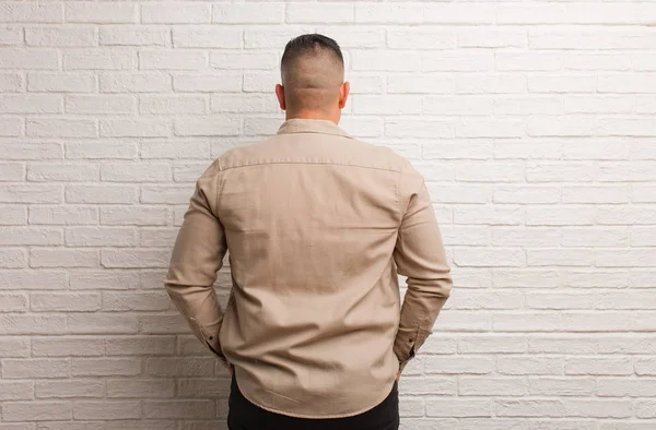 Young latin man from behind, looking back