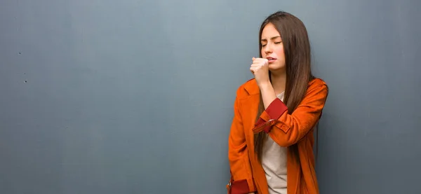 Young natural woman coughing, sick due a virus or infection