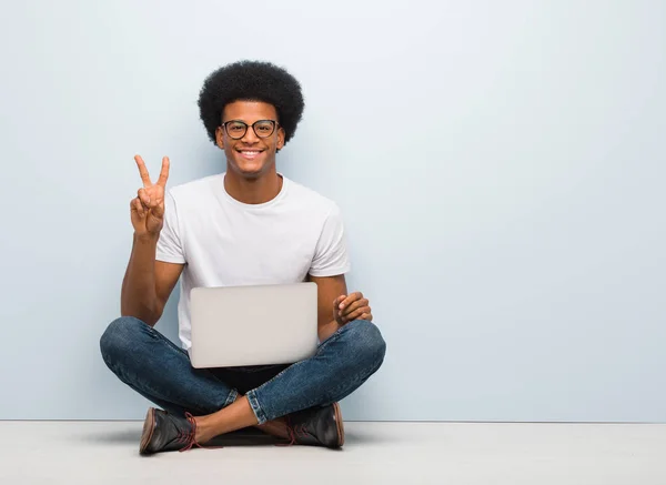 Jovem Negro Sentado Chão Com Laptop Mostrando Número Dois — Fotografia de Stock