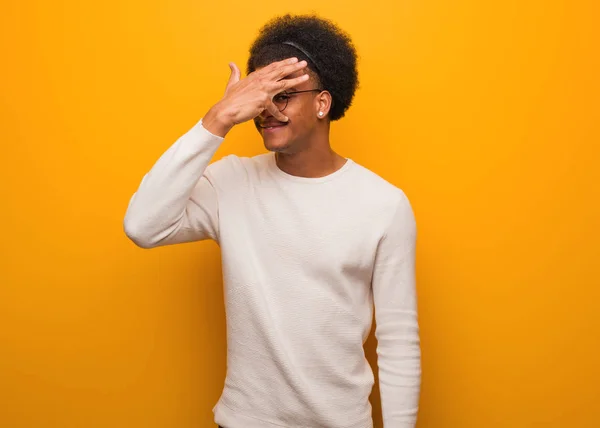 Young African American Man Orange Wall Embarrassed Laughing Same Time — Stok fotoğraf