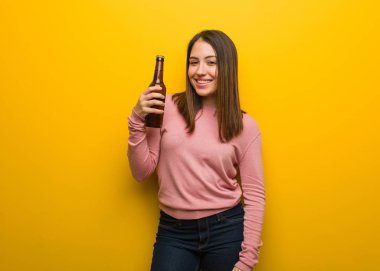 Büyük bir gülümseme ile bir bira neşeli tutan genç Sevimli Kadın