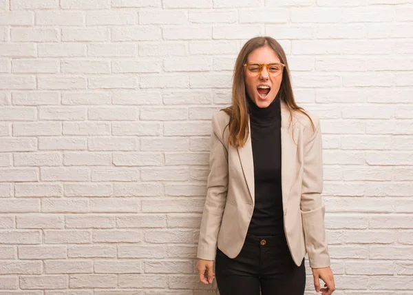 Young pretty business entrepreneur woman screaming very angry and aggressive