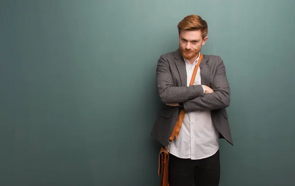 Young redhead business man crossing arms relaxed