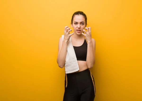 Young fitness girl angry and upset