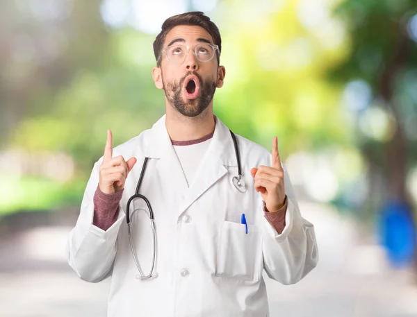 Young Doctor Man Surprised Pointing Show Something — Stock Photo, Image