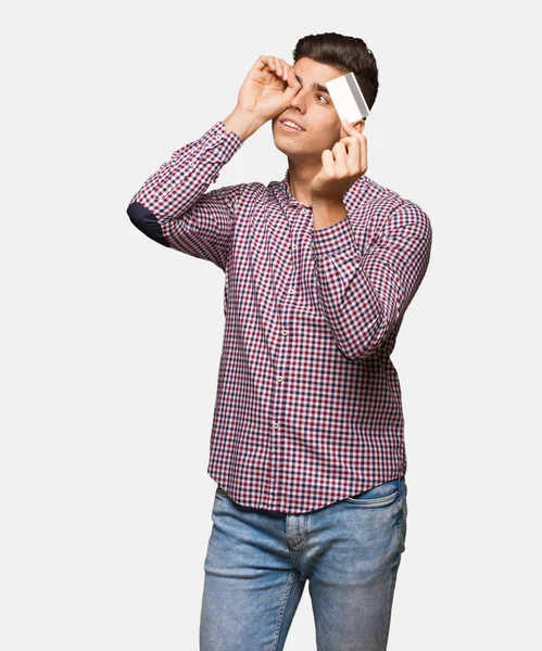 Young Man Holding Credit Card Making Gesture Spyglass — Stock Photo, Image