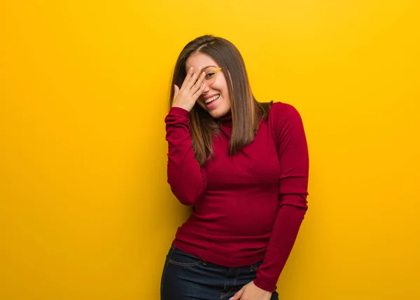 Young intellectual woman embarrassed and laughing at the same time