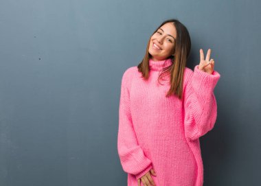 Genç modern kadın zafer jesti yapıyor