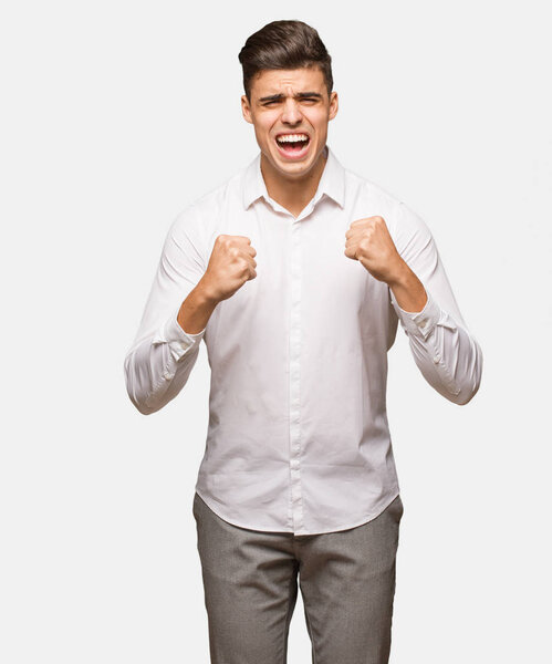 Young business cool man screaming very angry and aggressive