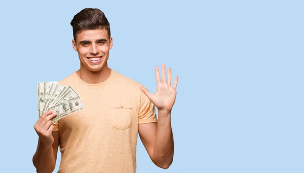 Young Man Holding Dollars Showing Number Five — Stock Photo, Image