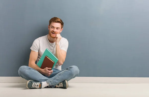 Young Redhead Student Man Sitting Floor Relaxed Thinking Something Looking — Stock Photo, Image