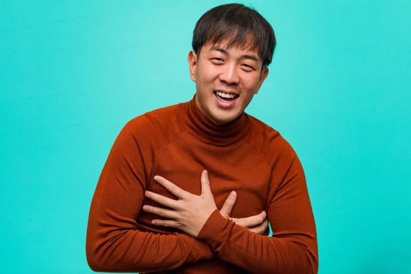 Young chinese man laughing and having fun