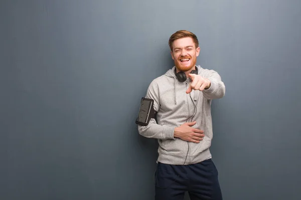 Young fitness redhead man dreams of achieving goals and purposes