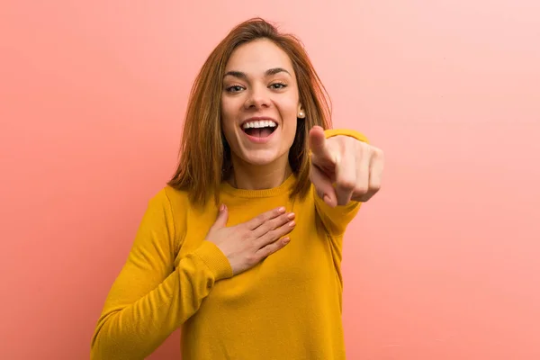 Young Pretty Young Woman Points Thumb Finger Away Laughing Carefree — 스톡 사진