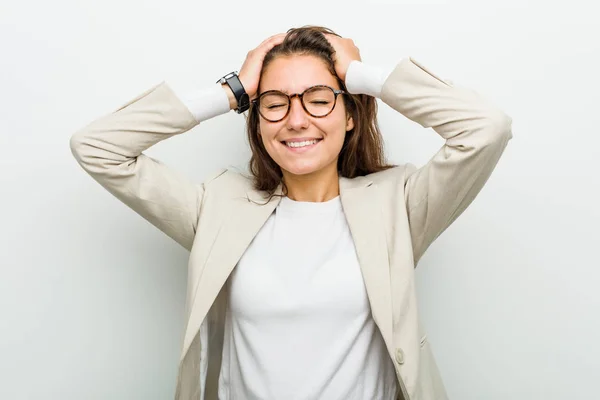 Young European Business Woman Laughs Joyfully Keeping Hands Head Happiness — 스톡 사진