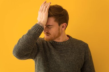 Genç kızıl saçlı adam. Kapalı bir yüz. Unutkan, bir şey fark et.