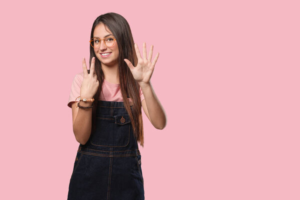 Young cool woman showing number seven